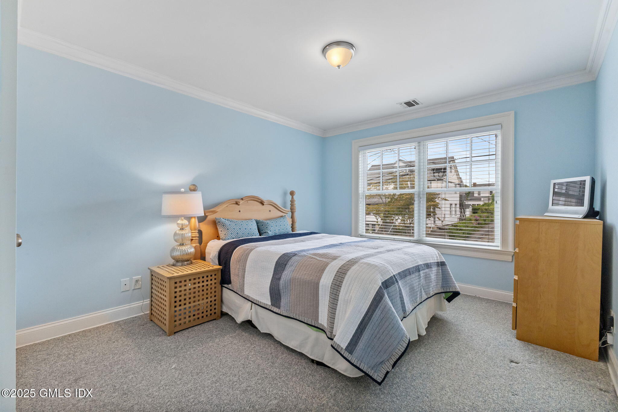 26 Church Street, Unit B Greenwich, CT 06830 - Photo 22 of 30 a spacious bedroom with a bed and a dresser next to a window