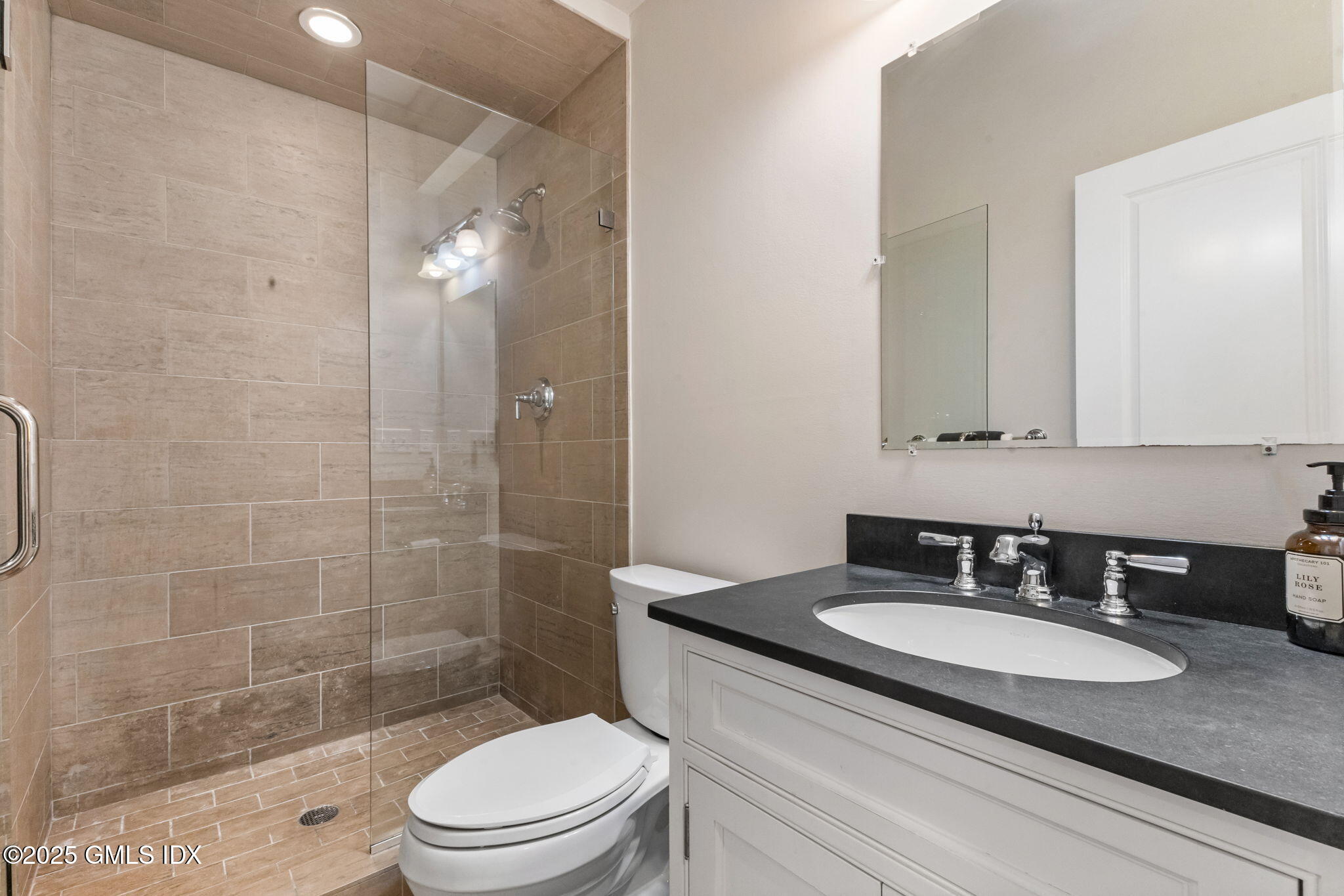 26 Church Street, Unit B Greenwich, CT 06830 - Photo 23 of 30 a bathroom with a sink a toilet and shower