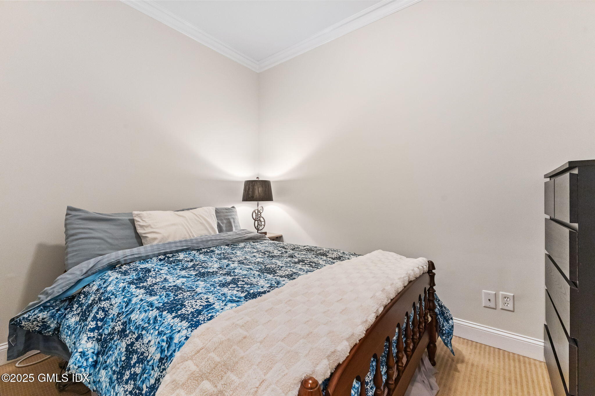 26 Church Street, Unit B Greenwich, CT 06830 - Photo 26 of 30 a bedroom with a bed and a flat tv screen on a dresser