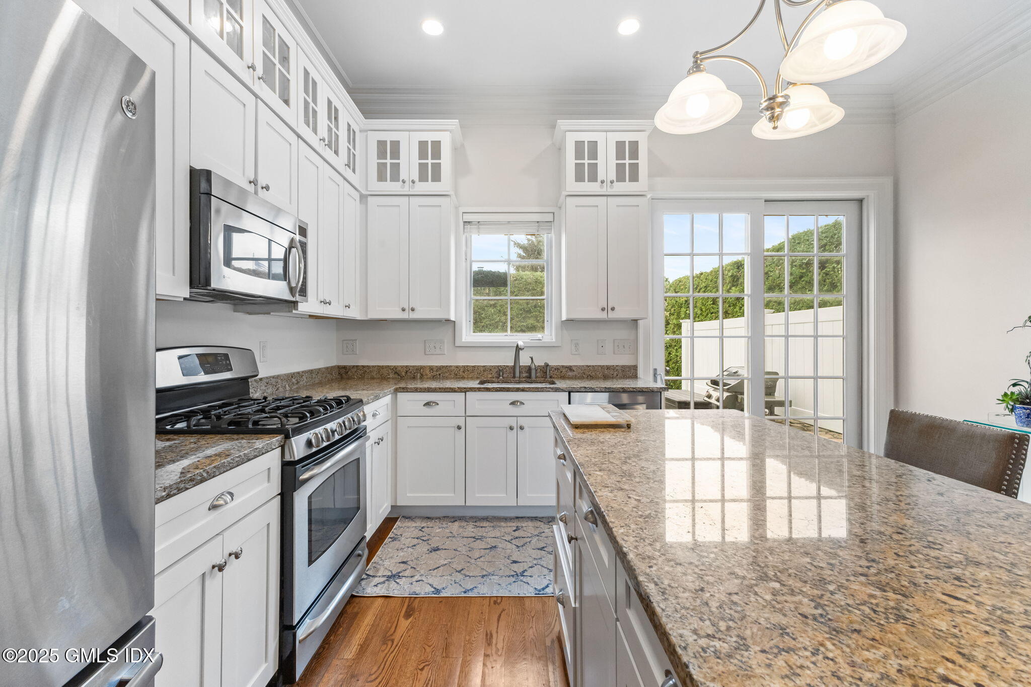 26 Church Street, Unit B Greenwich, CT 06830 - Photo 8 of 30 a kitchen with cabinets appliances and a wooden floor