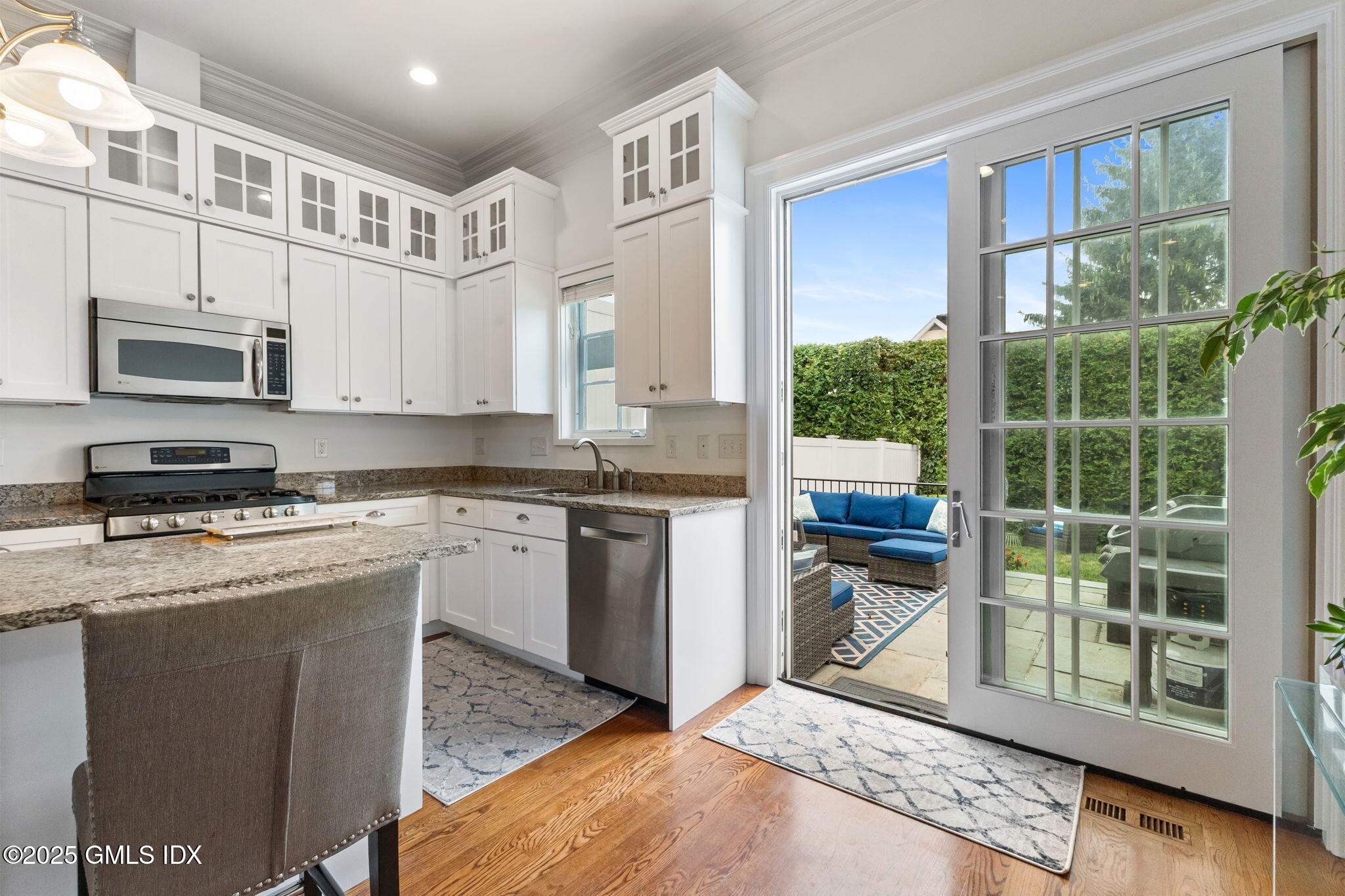 26 Church Street, Unit B Greenwich, CT 06830 - Photo 10 of 30 a kitchen with stainless steel appliances granite countertop a stove a sink and a microwave