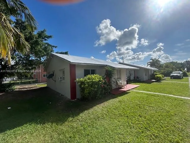 a view of a porch with furniture and a yard