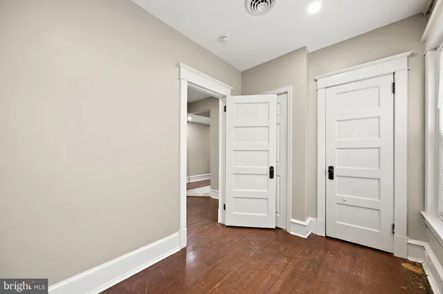 an empty room with wooden floor