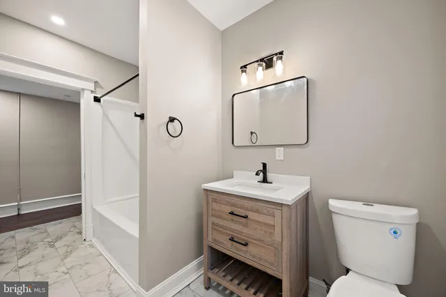 a bathroom with a toilet sink and shower