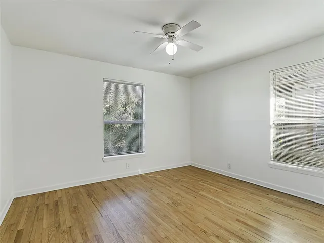 a white toilet sitting next to a shower