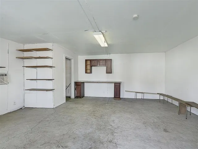 a view of a house with furniture and trees in the background
