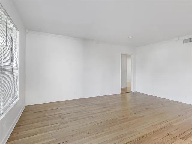 a view of an empty room and wooden floor