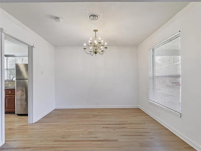 a view of a room with wooden floor and window