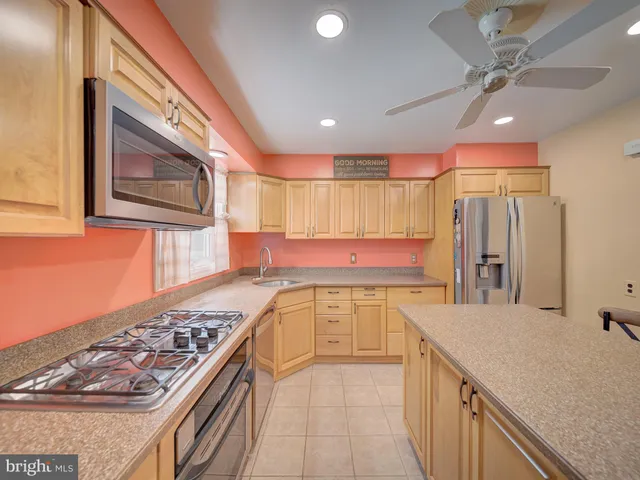 a kitchen with stainless steel appliances granite countertop a stove and a refrigerator