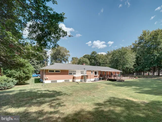 a aerial view of a house with swimming pool and a yard