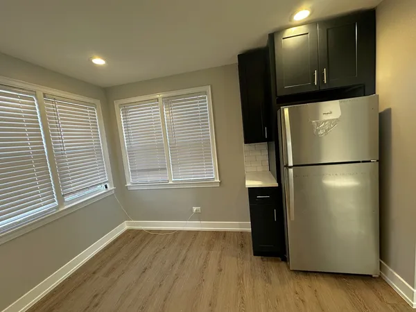 a view of a kitchen with a refrigerator and a microwave