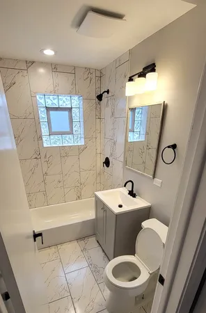 a bathroom with a sink toilet and shower