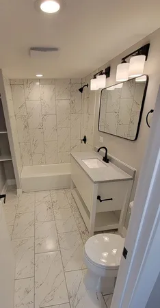a bathroom with a sink toilet and tub