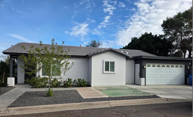 a front view of a house with garden