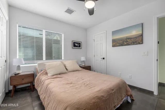a bedroom with a large bed and a window