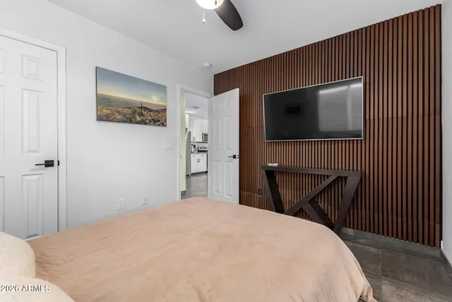 a bedroom with a bed and a television