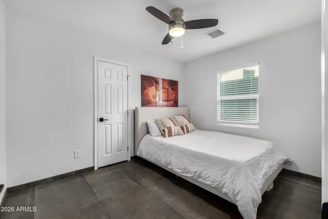 a bedroom with a bed and a window