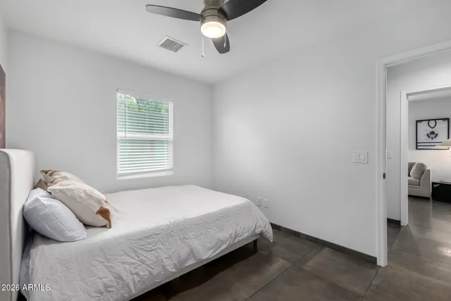 a bedroom with a bed and window