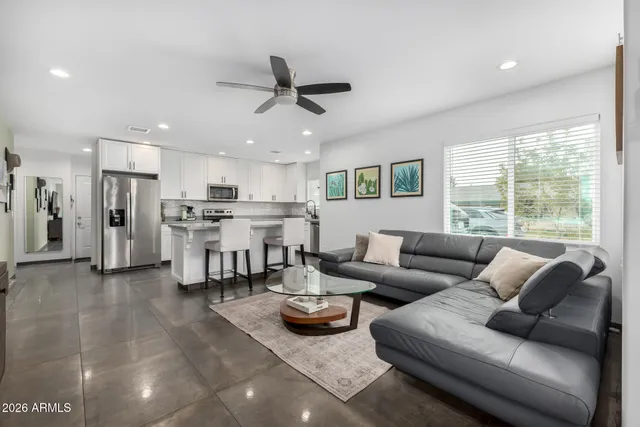 a living room with furniture and kitchen view