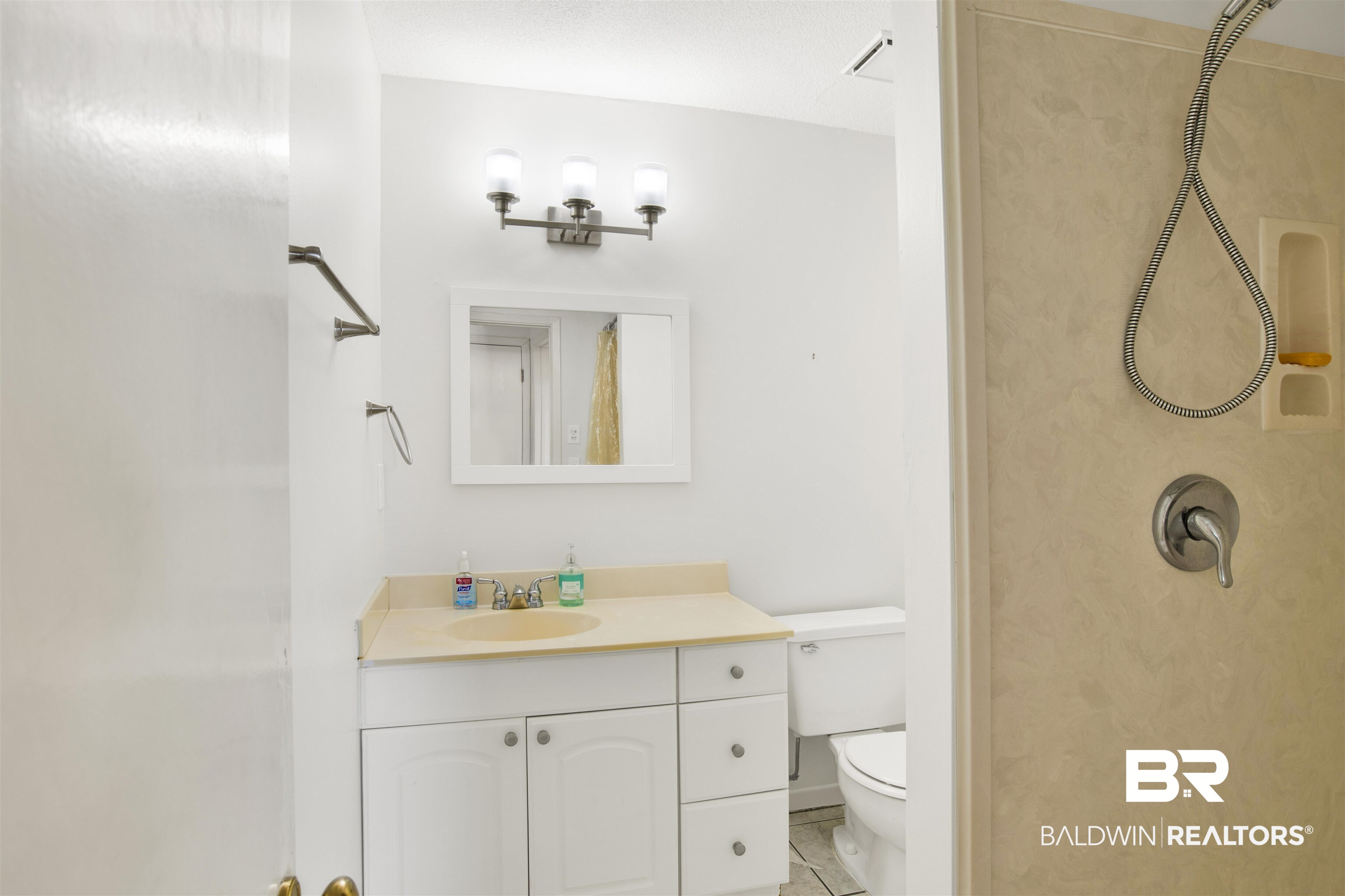 26913 Marina Road, Unit 213 Orange Beach, AL 36561 - Photo 18 of 30 Bathroom with vanity, toilet, and tile patterned flooring