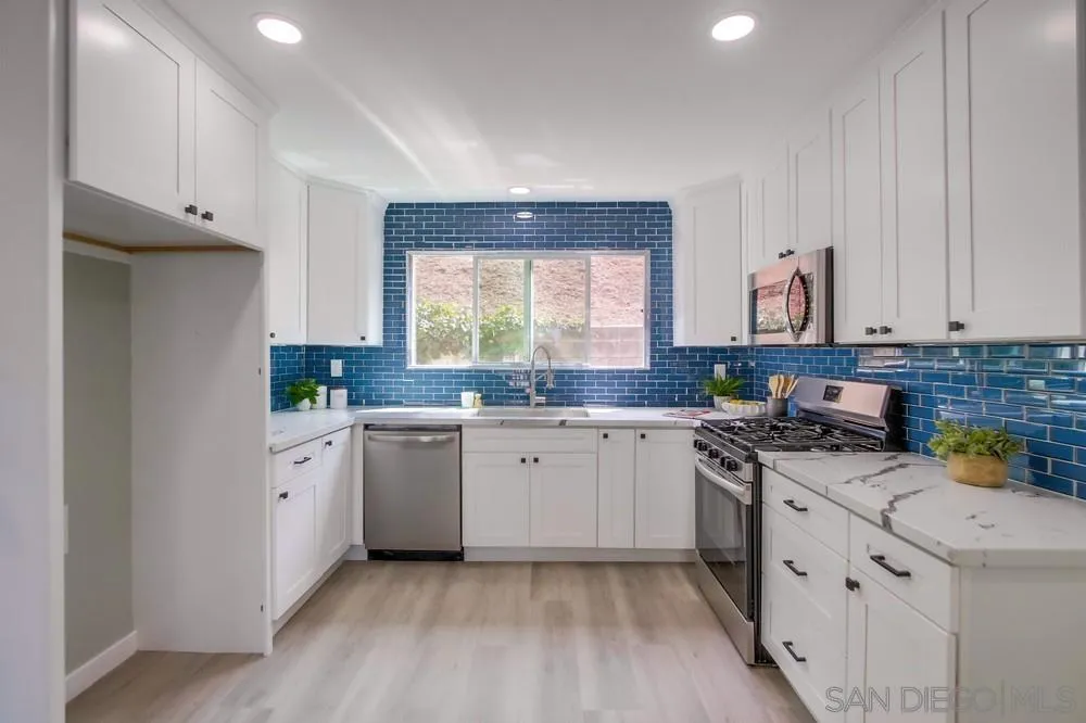 8535 Dobyns Drive Santee, CA 92071 - Photo 11 of 36 a kitchen with a white cabinets and window