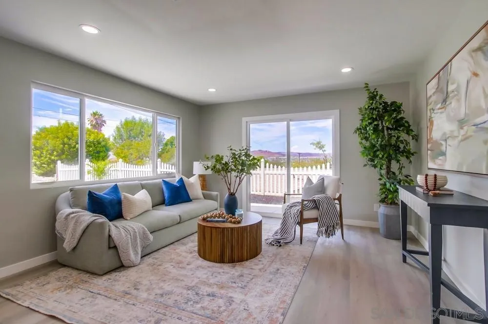 8535 Dobyns Drive Santee, CA 92071 - Photo 14 of 36 a living room with furniture potted plant floor to ceiling windows and a flat screen tv