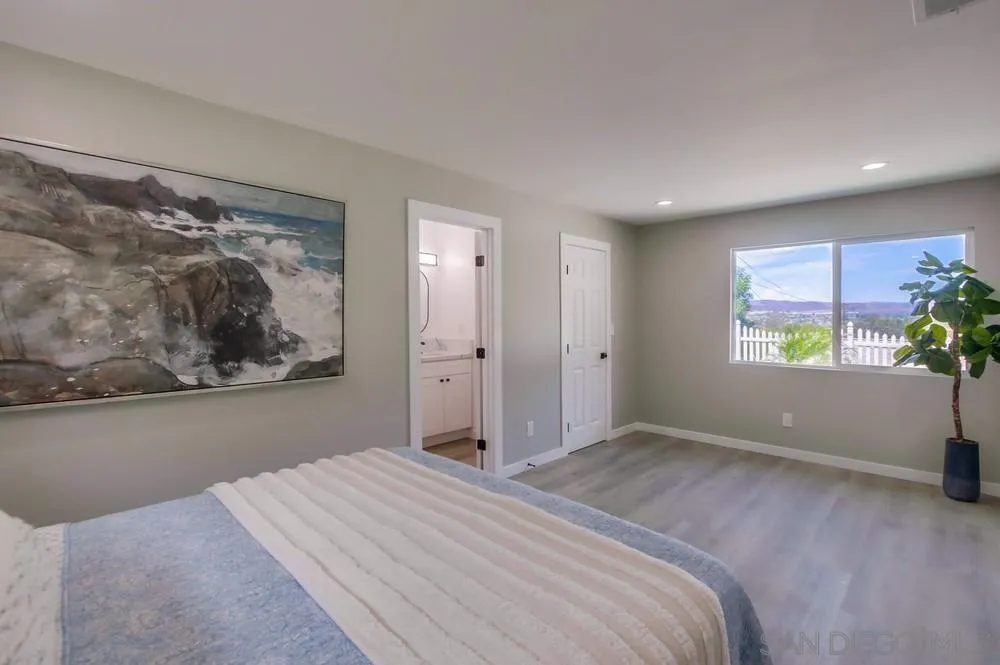 8535 Dobyns Drive Santee, CA 92071 - Photo 18 of 36 a bedroom with a bed and a painting on the wall