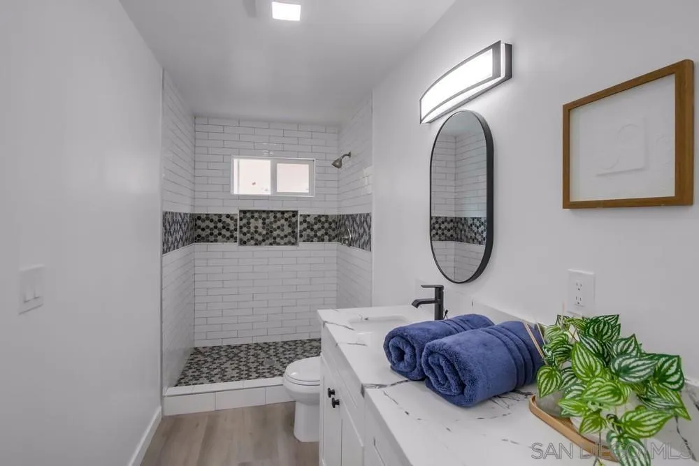 8535 Dobyns Drive Santee, CA 92071 - Photo 24 of 36 a bathroom with a sink a mirror and a shower