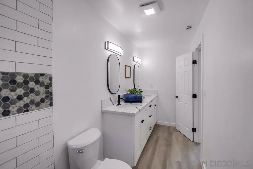 8535 Dobyns Drive Santee, CA 92071 - Photo 25 of 36 a bathroom with a granite countertop sink mirror vanity and toilet