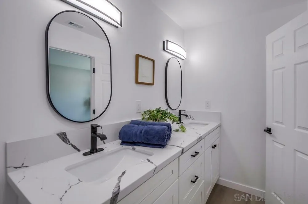 8535 Dobyns Drive Santee, CA 92071 - Photo 27 of 36 a bathroom with a sink and a mirror
