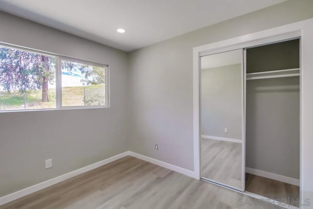 8535 Dobyns Drive Santee, CA 92071 - Photo 28 of 36 an empty room with wooden floor and windows