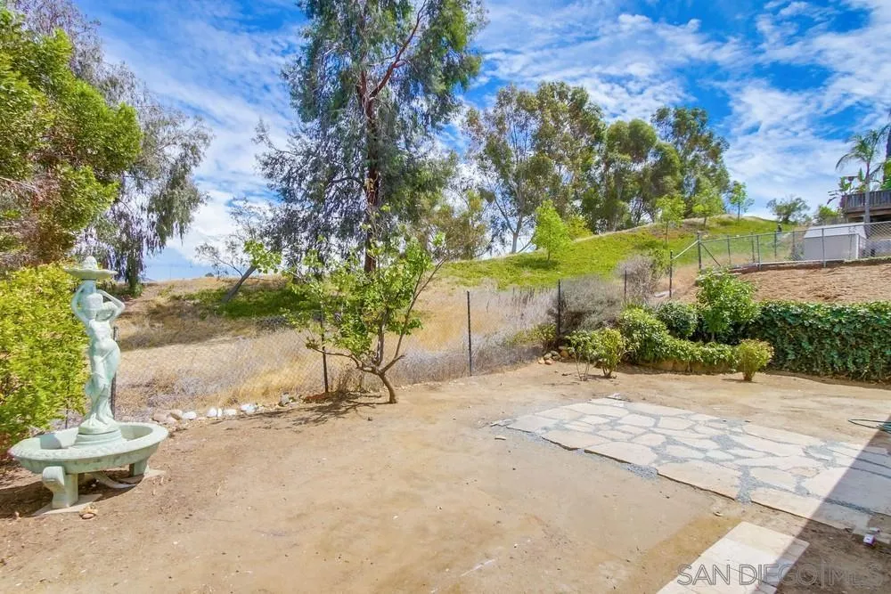 8535 Dobyns Drive Santee, CA 92071 - Photo 36 of 36 a view of a yard with plants and a bench