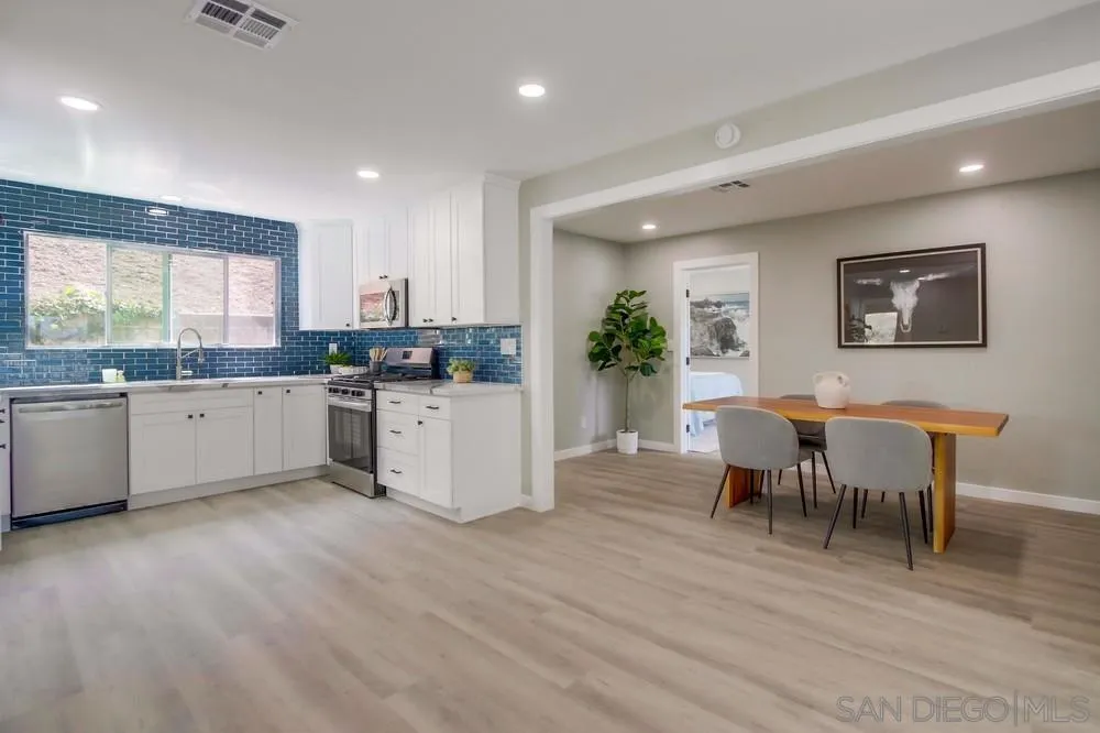 8535 Dobyns Drive Santee, CA 92071 - Photo 7 of 36 a kitchen with granite countertop cabinets a dining table and chairs