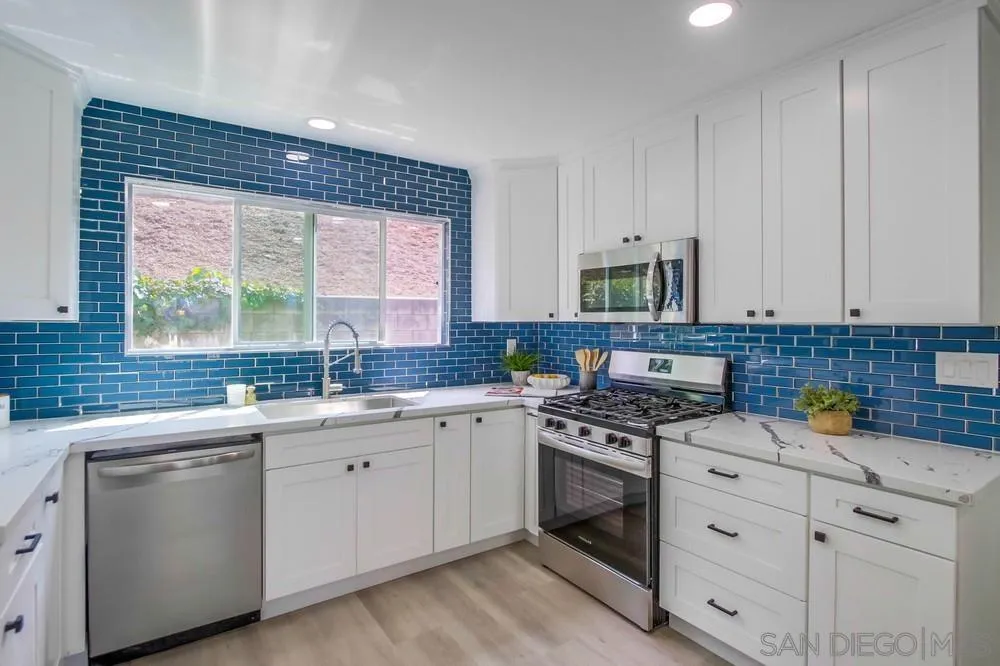 8535 Dobyns Drive Santee, CA 92071 - Photo 8 of 36 a kitchen with white cabinets appliances a sink and a window