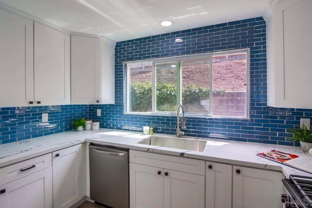 8535 Dobyns Drive Santee, CA 92071 - Photo 10 of 36 a kitchen with stainless steel appliances a sink stove and cabinets