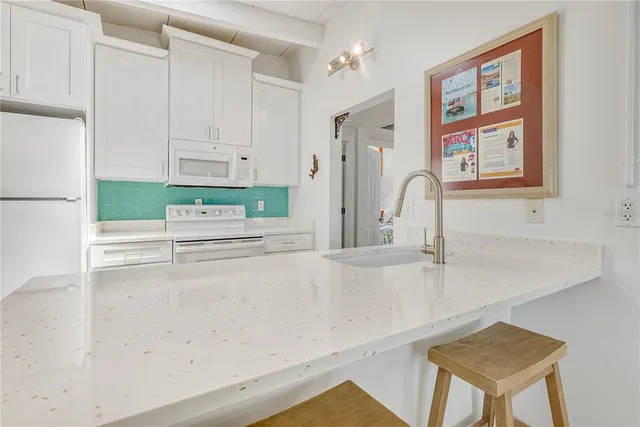 a kitchen with stainless steel appliances a sink a stove and a refrigerator