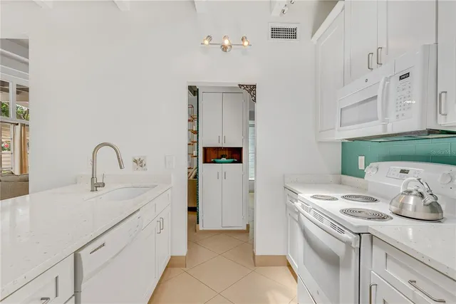 a kitchen with a sink and a stove top oven