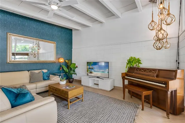 a living room with furniture and a piano