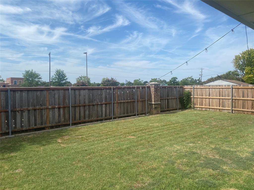 9733 Old Field Drive McKinney, TX 75072 - Photo 11 of 12 a view of a backyard with brick wall