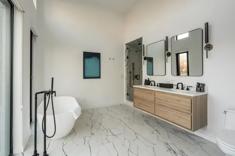 a bedroom with a large bed and a large window