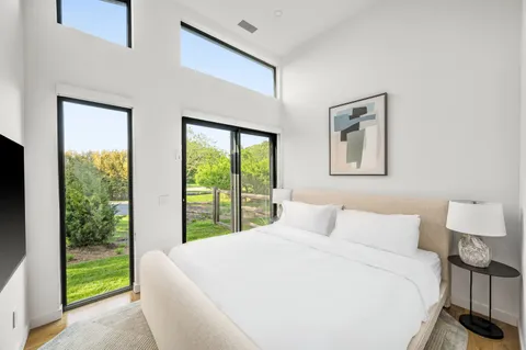 a spacious bathroom with a double vanity sink mirror and bathtub
