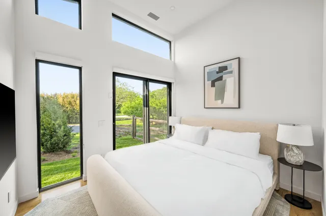 a spacious bathroom with a double vanity sink mirror and bathtub