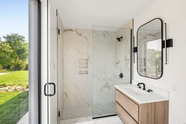 a bedroom with a large bed and a window