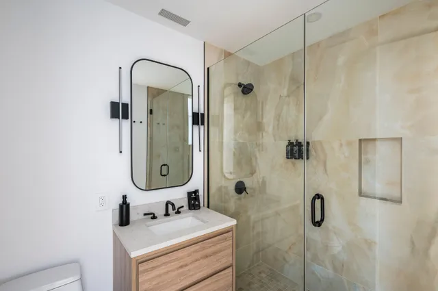 a large bedroom with a bed and glass window