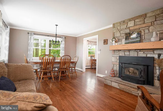 a living room with furniture dining table and a flat screen tv