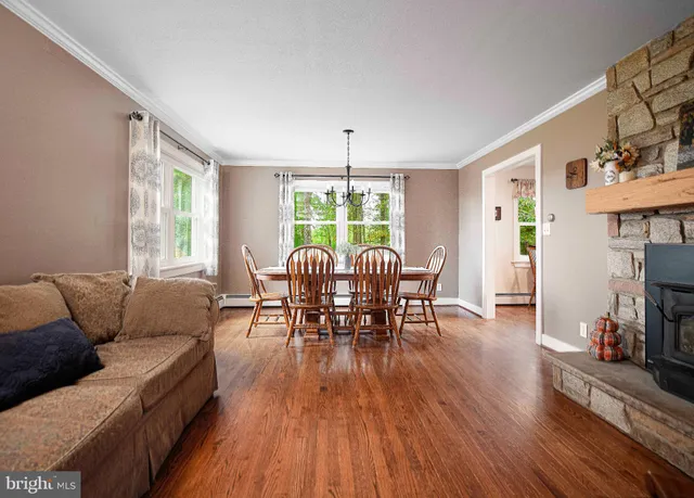 a view of a dining room with furniture window and wooden floor
