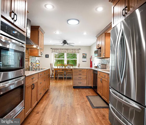 a kitchen with sink a microwave and cabinets