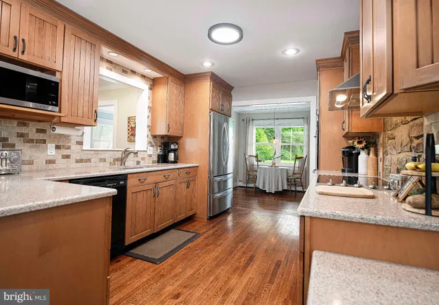a dining room with wooden floor and window