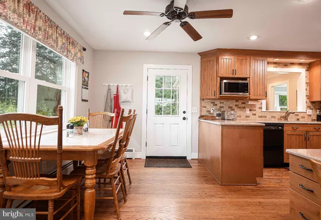 a kitchen with stainless steel appliances sink refrigerator and large window
