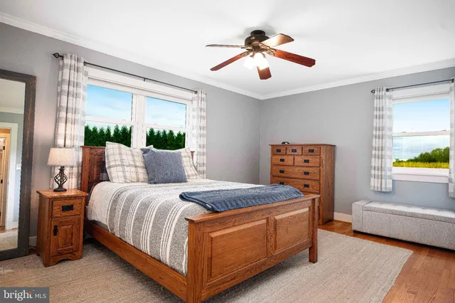 a bed sitting in a spacious bedroom next to a window